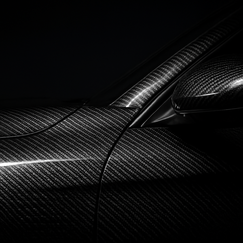 Carbon fiber wrap detail on a car hood and mirror